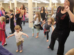 Moms and kids during a ballroom dance lesson.