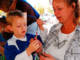 Young boy trying out beading.