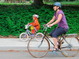 Mother and daughter having fun cycling together