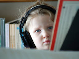 A little girl studying music