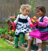 Waikato Kindergarten Association girls sharing and laughing