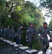 River crossing to bush battle paintball at Combat Zone Whitianga