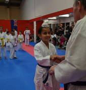 A young 7 year old student receiving his certificate