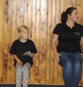 Miss Antz and a student, practising sitting in an invisible chair